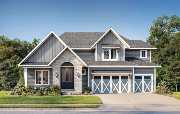 Two-story suburban home with gray siding, stone entry, and a two-car garage, front lawn and driveway visible.