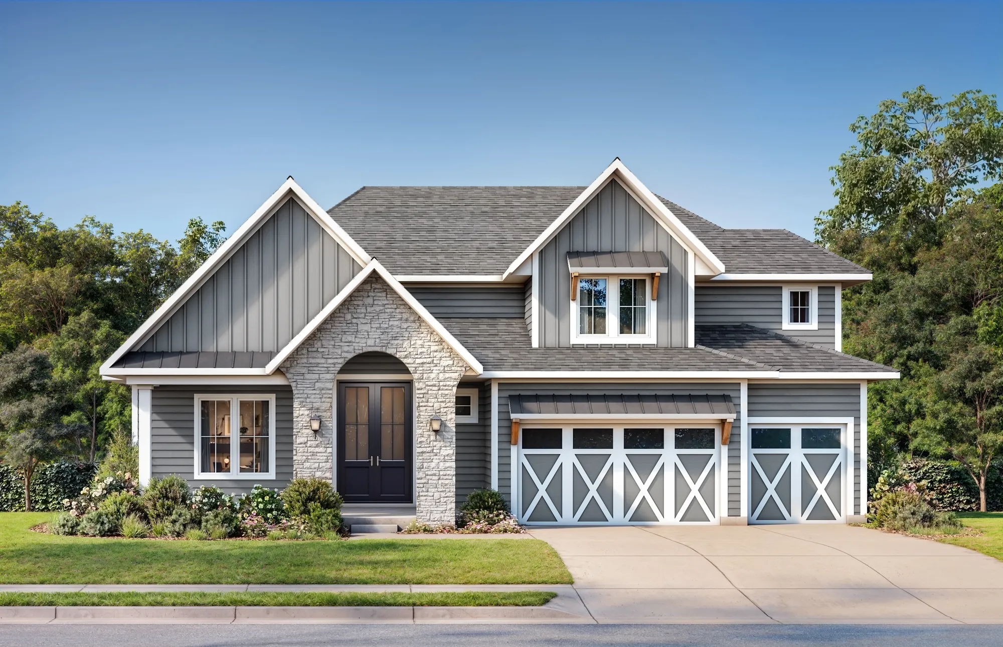 Front view of a two-story gray house with stone entry, gabled roof, and white-trimmed two-car garage doors.
